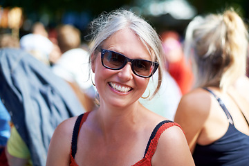 Image showing Senior, woman and portrait with sunglasses outdoor in crowd, happy and festival on vacation for fun. Person, lifestyle and concert on holiday for music, event and smiling with people or audience