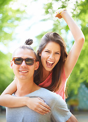 Image showing Love, portrait and happy couple with piggyback in a park for freedom, celebration or bonding outdoor. Travel, energy and excited people face in forest for fun vacation, holiday or back ride adventure