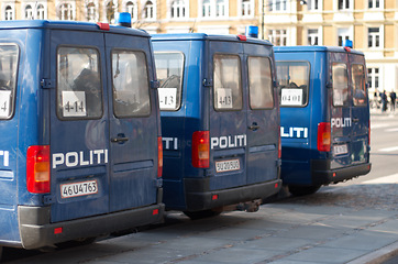 Image showing Police, van and street with transport, safety and protection service for public with justice in city. Vehicle, law enforcement and outdoor for danger, arrest and patrol on urban road in Copenhagen