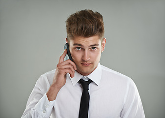 Image showing Portrait, studio and man with phone call while meeting sales targets and KPI with gray background. Professional salesman, financial advisor or smartphone with shirt, tie or trendy haircut for mockup