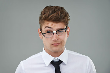 Image showing Businessman, glasses and funny portrait in studio for optical healthcare, comedy and humor on gray backdrop. Male person, eyewear and joking with frame choice, optometry and lens for vision support