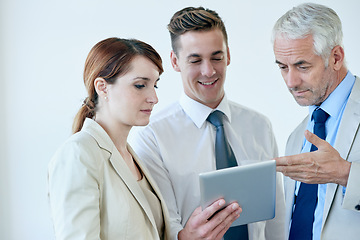 Image showing Business people, tablet and discussion on project for partnership, communication and meeting in office. Coworkers, collaboration and tech for research on internet, planning and teamwork in workplace