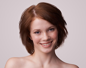 Image showing Portrait, woman and skincare with smile in studio, white background and red hair with treatment for self care. Face, and glow with natural routine for smooth, skin and confidence with moisturizer