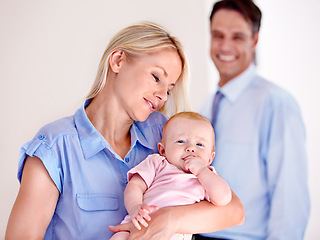 Image showing Baby, happy and cute with mom as family in a home and dad smile for child with love and marriage. Man, relax and together with woman as parents to a kid with care and happiness or trust of mother