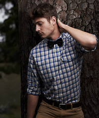 Image showing Fashion, serious and hipster with man in nature for retro, trendy and vintage style. Confidence, funky and casual with young male person shirt in urban outdoors for cool, elegant and attractive