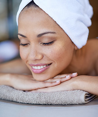 Image showing Luxury, woman and relax on massage bed with smile for wellness, zen and beauty treatment for body care. Person, stress relief and peaceful at resort, salon table and spa on holiday or vacation