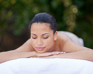 Image showing Spa, woman and relax on massage bed with smile for wellness, zen and beauty treatment for body care. Person, sleeping and stress relief at resort, salon table and peaceful on holiday or vacation