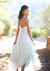 Image showing Portrait, wedding dress and back with woman, outdoor and sunshine with celebration and happiness. Person, park and girl with ceremony and summer with weekend break and beauty with a smile and bride