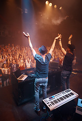 Image showing Night, club and arms raised for dj at celebration with fans at stage for performance with piano and musician. Music festival, crowd and people with talent playing for audience in theater with energy