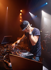 Image showing DJ, headphones and audio on stage for sound check with turntables at concert in Australia. Male producer, mic and spotlights at club, party or festival for EP release, album or live music performance