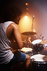 Image showing Stage, performance and drummer at concert with man in band with energy and talent for music. Drums, musician and person playing in theater spotlight with rhythm for instrument and show at night