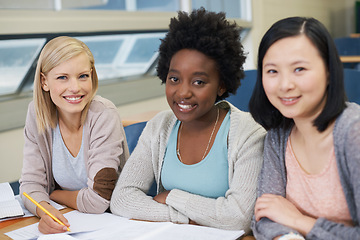 Image showing Woman, students and studying in university lecture hall with notes, prepare and plan for exam. Ideas, smile and focus on plan for determination, knowledge and information for assessment task