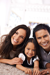 Image showing Portrait, happy family and relax on floor for care, bonding or love together at home. Face of mother, father and little girl, daughter or child with smile in living room for holiday weekend at house