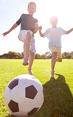 Image showing Kids, soccer ball and field outdoor with fun, bonding and summer play with smile from sport. Running, happy and game with young children on a lawn for match with friends or sibling with football