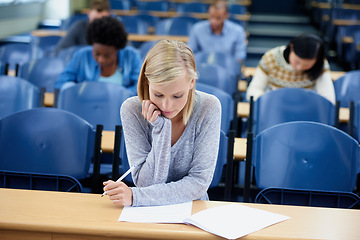 Image showing Student, exam and thinking with pen for education with brainstorming, knowledge and assessment at university. Woman, planning and sitting with paper for idea, learning and growth in campus class