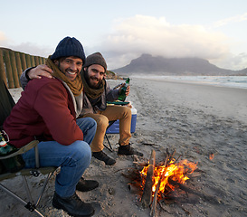 Image showing Men, sunset and campfire with portrait, smile and happy from travel adventure and journey outdoor. Friends, ocean and sea with bonding, hug and vacation by the beach together on holiday with fire