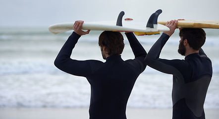 Image showing Man, friends and surfer on beach for fitness, sport or waves on shore in outdoor exercise. Rear view of male person or people with surfboard for surfing challenge, tide or hobby by ocean in nature