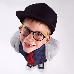 Image showing Glasses, smile and portrait of child in studio for eye care, vision and optical health. Happy, optometry and top view of young boy kid with stylish eyewear or spectacles isolated by gray background.