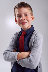 Image showing Smile, crossed arms and portrait of child in studio with classy, elegant and fashion shirt and tie. Happy, cute and young boy kid with fancy style with confidence isolated by gray background.
