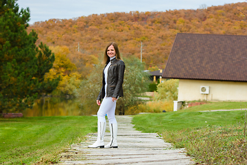 Image showing Portrait of a young beautiful girl in casual clothes in a beautiful forest village