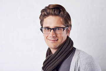 Image showing Smile, glasses and portrait of man by wall with casual, cool and trendy outfit for confidence. Happy, handsome and young male person with spectacles and style standing by white brick background.