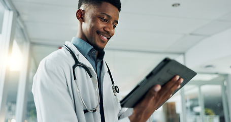 Image showing Tablet, research and happy black man doctor on internet for medical or healthcare information online in a hospital. Smile, medicine and professional typing on health website or app in a modern clinic