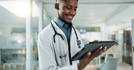 Image showing Tablet, research and happy black man doctor on internet for medical or healthcare information online in a hospital. Smile, medicine and professional typing on health website or app in a modern clinic