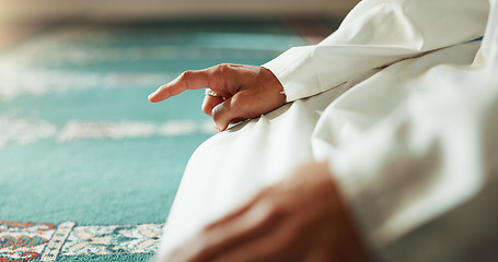 Image showing Islam, floor and closeup of a pointing finger or person at a mosque for praying, hajj or support. Muslim, hope and hand of a man for a prayer, gesture or worship for respect, religion or trust