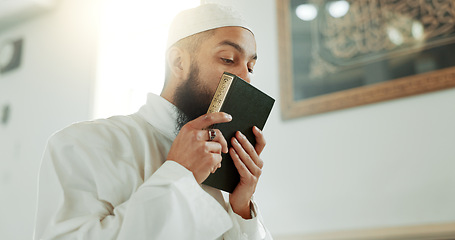 Image showing Islam, kiss and man in mosque with Quran, mindfulness and gratitude in faith reading. Worship, religion and love, Muslim Imam in holy temple for praise, spiritual teaching and peace in prayer at Eid.