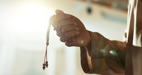 Image showing Muslim, prayer beads and hand of man in mosque with tasbih for spiritual, meditation and mindfulness in religion. Counting, dhikr and person praying in Islam, faith with hope in God in the morning