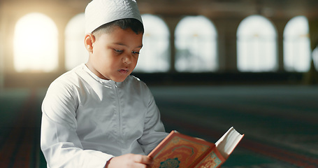 Image showing Islam, child in mosque reading Quran for learning, mindfulness and gratitude in faith with prayer. Worship, religion and Muslim student in holy temple praise with book, spiritual teaching and study.