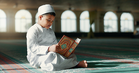 Image showing Islam, boy in mosque reading Quran for learning mindfulness and gratitude in faith with kids prayer. Worship, religion and Muslim student in holy temple praise with book, spiritual teaching and study