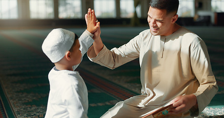 Image showing Muslim, high five in a mosque and a father with his son to study the quran for faith, belief or religion together. Family, kids and ramadan with a man teaching his boy child about islamic success