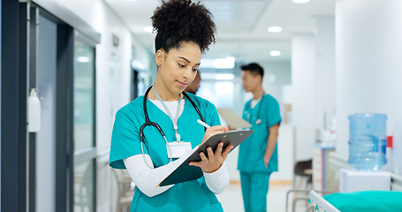 Image showing Doctor, holding and writing on clipboard in hospital for patient, care or treatment after exam in emergency room. Woman, nurse and medicine after consulting for health, wellness or surgery in space