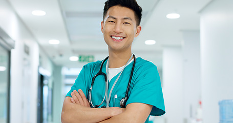 Image showing Face, doctor and confident with smile in hospital with arms crossed for leadership in medicine. Asian man, person or nurse in cardiology, emergency care or health for treatment of patient at clinic