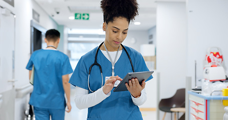 Image showing Woman, doctor and tablet walking at hospital for research, schedule planning or communication in hallway. Female person, nurse or medical worker with technology for Telehealth or networking at clinic