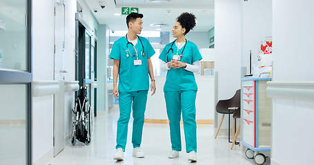 Image showing Hospital, nurse and people in corridor walking, talking and in discussion for advice, care and help. Healthcare, nursing team and man and woman speaking for medical service, diagnosis and consulting