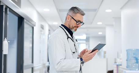 Image showing News, tablet or mature doctor in hospital with research on website to search for medicine info online. Man reading, senior or medical healthcare nurse browsing on technology for telehealth in clinic