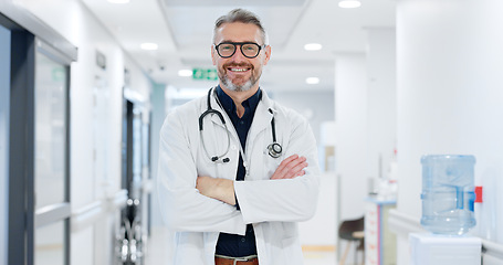 Image showing Professional, face and man or doctor with arms crossed for wellness, trust and service in hospital or clinic. Portrait, person and expert with happiness for career, cardiology or glasses at workplace