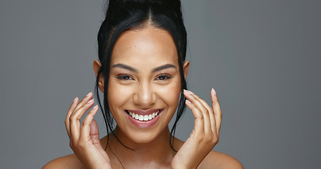 Image showing Face, skincare and hands of happy woman in studio isolated on a gray background. Portrait, natural beauty and model touch in spa facial treatment for aesthetic, glow and cosmetic wellness for health