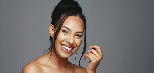 Image showing Face, skincare and happy woman wink in studio isolated on a gray background. Portrait, natural beauty and model flirting in spa facial treatment for aesthetic, glow and cosmetic wellness for health