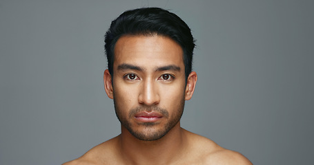 Image showing Face, cosmetics and Asian man with beauty, skincare and dermatology on a grey studio background. Portrait, Japanese person and model with wellness, luxury treatment and spa grooming with aesthetic