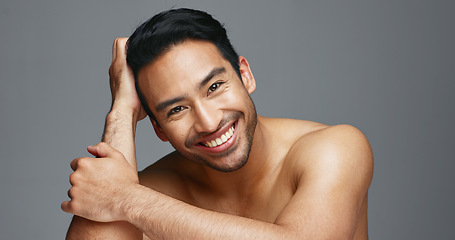 Image showing Face, cosmetics and Asian man with skincare, smile and dermatology on a grey studio background. Portrait, Japanese person and happy model with wellness, luxury treatment and beauty with aesthetic