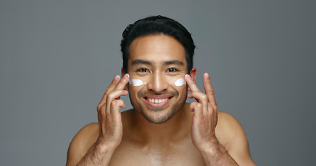 Image showing Face, cream and man with skincare, glow and dermatology with grooming, wellness and shine on grey studio background. Portrait, person or model with creme, beauty or cosmetics treatment with aesthetic