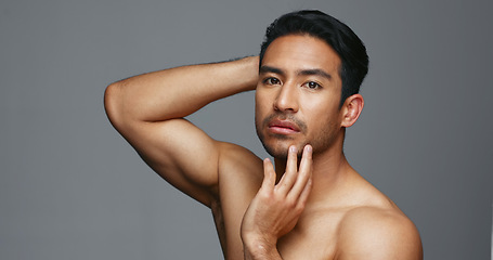 Image showing Face, cosmetics and Asian man with dermatology, shine and luxury treatment on a grey studio background. Portrait, Japanese person or model with wellness, glow and spa grooming with aesthetic and soft