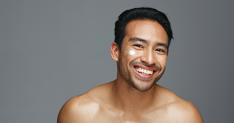 Image showing Face, cream and man with skincare, dermatology and beauty with glow on a grey studio background. Portrait, person and model with creme, smooth and luxury treatment with grooming, shine and aesthetic