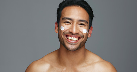 Image showing Face, cream and man with skincare, glow and dermatology with grooming, wellness and shine on grey studio background. Portrait, person or model with creme, beauty or cosmetics treatment with aesthetic