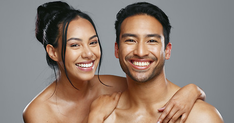 Image showing Couple, smile and care for skincare, happy and portrait for wellness in studio by gray background. Happy people, dermatology and hug for cosmetics, hydration and glow or love for skin treatment