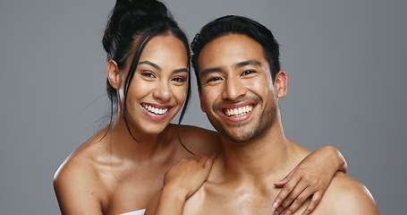 Image showing Couple, smile and care for skincare, happy and portrait for wellness in studio by gray background. Happy people, dermatology and hug for cosmetics, hydration and glow or love for skin treatment