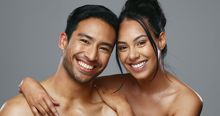 Image showing Couple, smile and care for skincare, love and portrait with moisturizer in studio by gray background. Happy people, dermatology and hug for cosmetics, hydration and creme or happy for skin treatment